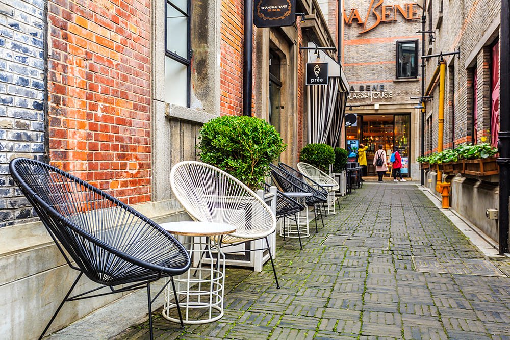 Een klein steegje met tafels langs de weg in Heerhugowaard